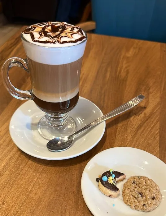 Café con leche en capas con dos cookies caseras en Tolón
